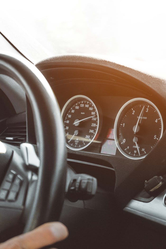 our-experience Close-up of a car's speedometer and dashboard illustrating modern vehicle design.